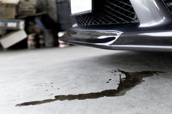Fluid leak underneath the front of a car, poured on cement