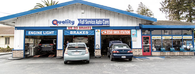 Outside of repair shop, vehicles parked ready for repair | Quality Tune-Up Auto Care