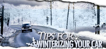 Tips For Winterizing Your Car | Vehicle driving on icy road surrounded by snow on trees