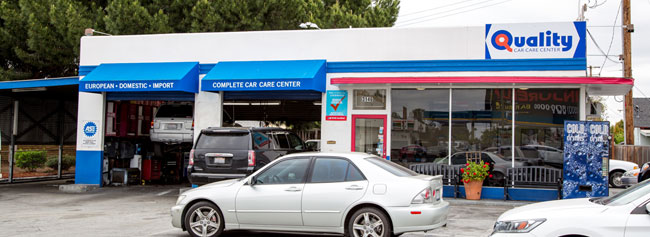 Outside of shop with vehicles parked outside | Quality Tune-Up Auto Care