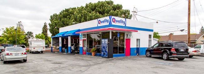 Outside of shop with vehicles parked | Quality Tune-Up Auto Care